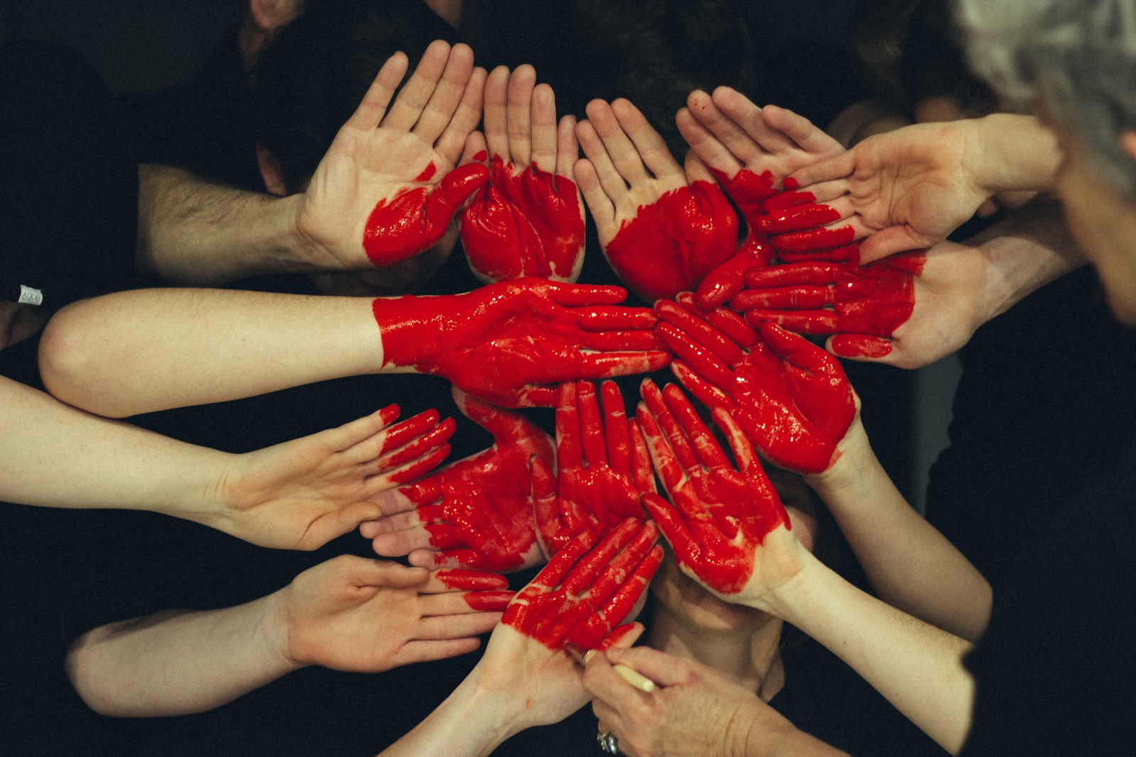 Photo by Tim Marshall hands formed together with red heart paint