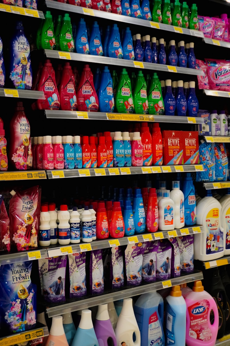 Photo by Adhitya Sibikumar Shelves stocked with various cleaning supplies and detergents.