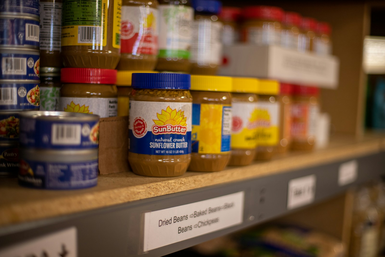 Photo by Aaron Doucett assorted plastic containers on brown wooden shelf