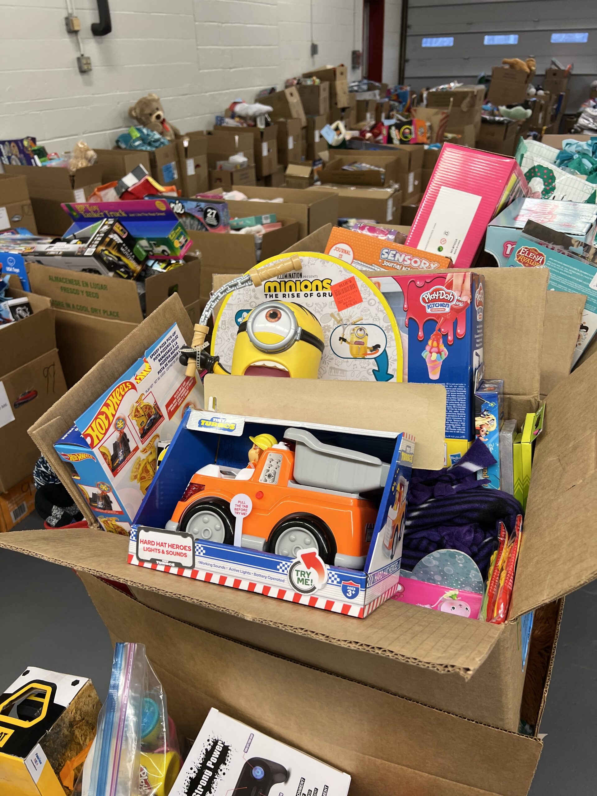 assorted plastic containers on brown wooden shelf