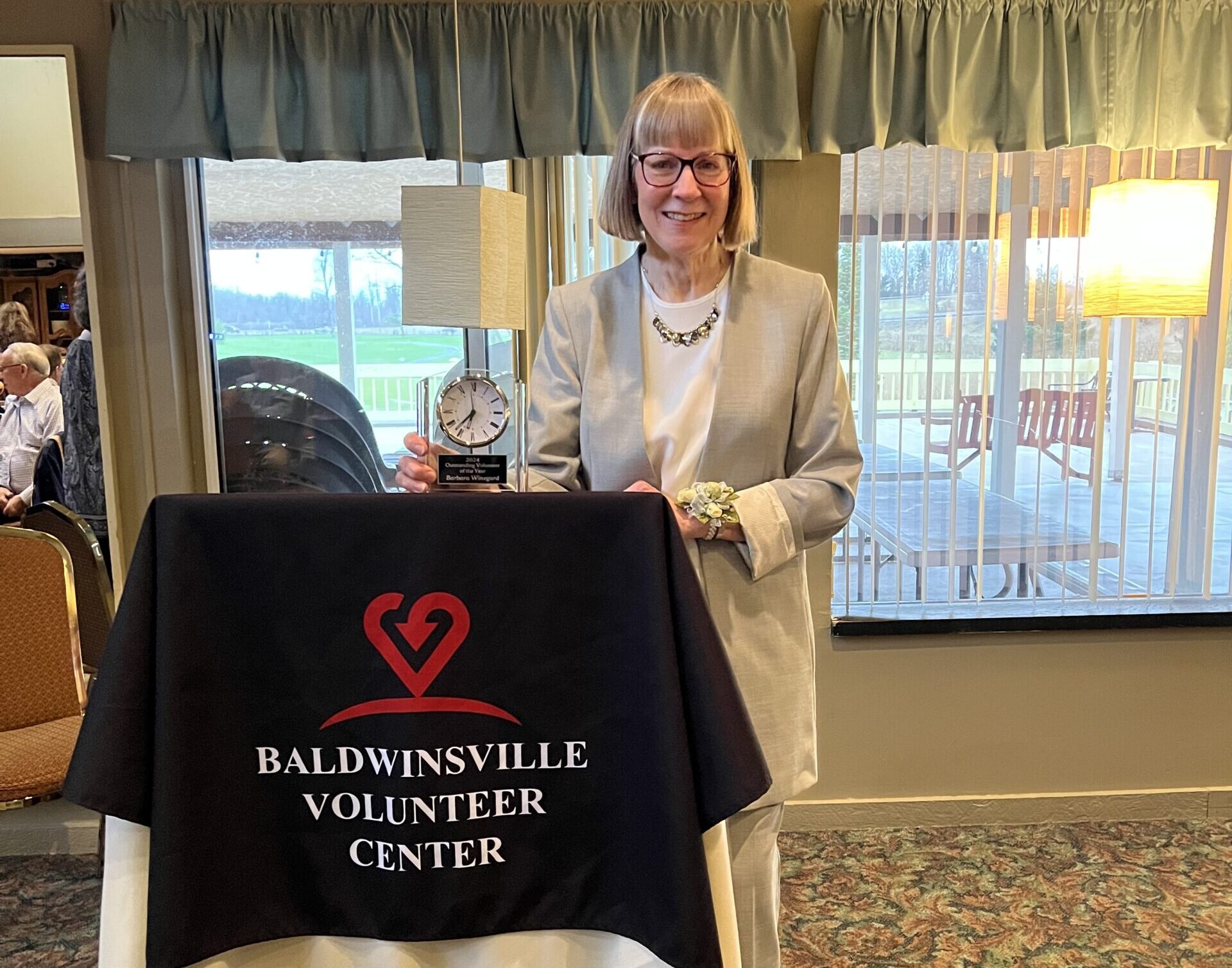 woman in white t-shirt and blue denim jeans sitting on brown cardboard box